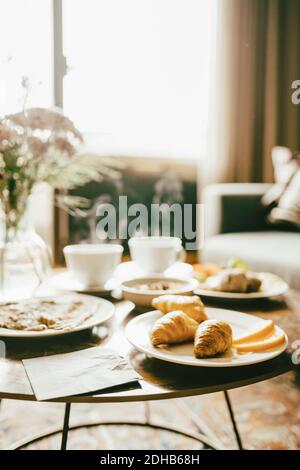 Fresh breakfast served on table in hotel room Stock Photo
