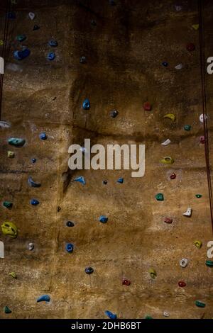 climbing wall with different colored handles in a modern gym Stock Photo