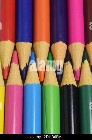 colored pencils arranged head to head isolated on a white background. wooden pencils background Stock Photo