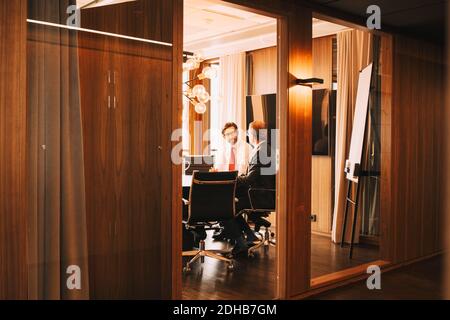 Male financial advisors discussing in board room at law office Stock Photo