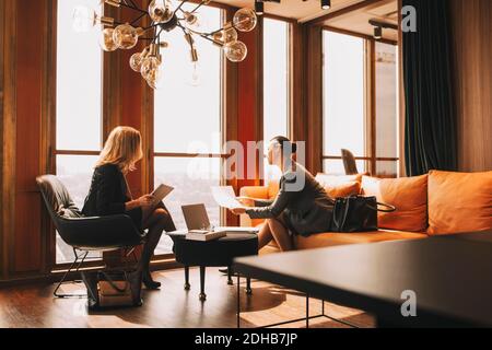 Legal colleagues discussing over documents in law office Stock Photo