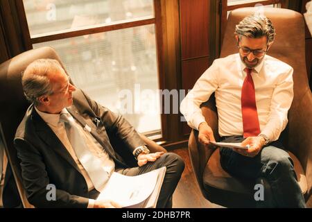 High angle view of legal colleagues discussing over documents at law office Stock Photo