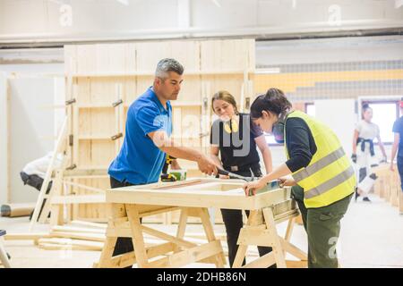 Young female trainees learning from male instructor at workshop Stock Photo