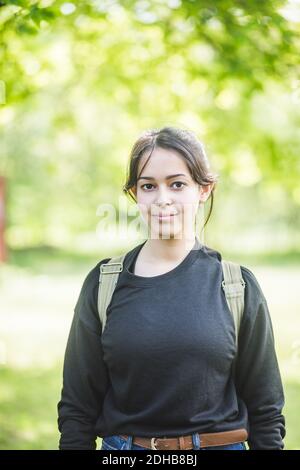 Portrait of smiling young woman standing outdoors Stock Photo