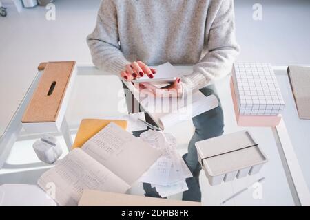 High angle midsection of female interior designer using digital tablet at desk in store Stock Photo