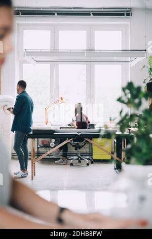 Businessman and businesswoman working in creative office Stock Photo