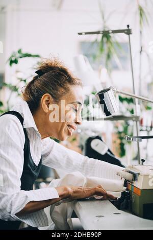 Smiling businesswoman working in creative office Stock Photo