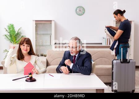 Old experienced judge and young couple in divorcing concept Stock Photo