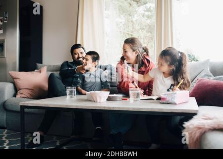 Happy family spending leisure time in living room Stock Photo