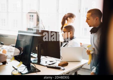 Male and female programmers working at creative office Stock Photo