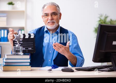 Old male author writing screenplay Stock Photo