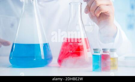Funny mad chemist working in a laboratory Stock Photo