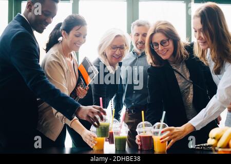 Business colleagues enjoying drinks during coffee break in conference Stock Photo