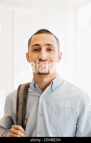 Portrait of smiling IT programmer standing in office Stock Photo