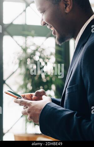 Businessman using mobile phone at office Stock Photo