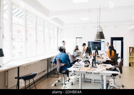 Computer programmers discussing over code during meeting in creative office Stock Photo