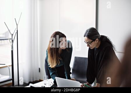 Businesswoman working on laptop in office Stock Photo