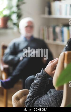 Man with therapist in home office Stock Photo