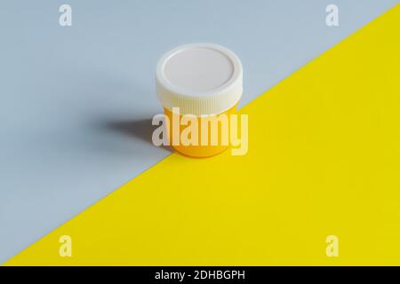 Demonstrating trendy colors 2021 - Gray and Yellow. can with yellow gouache paint . Stock Photo