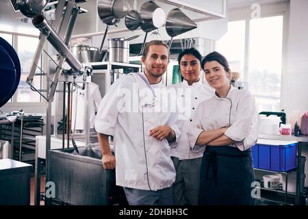 Portrait of multi-ethnic chefs standing in commercial kitchen Stock Photo