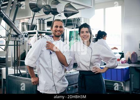 Portrait of chefs smiling in commercial kitchen Stock Photo