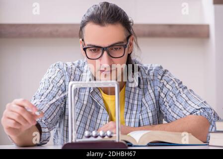 Young male student preparing for exam at home Stock Photo