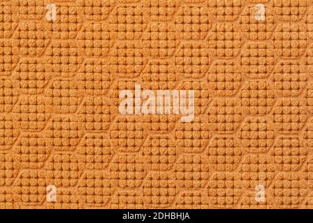 Texture of genuine suede leather embossed geometric mosaic pattern close-up, looks like a honeycomb brown. Modern natural background Stock Photo