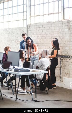 Team of happy computer hackers working together in creative office Stock Photo