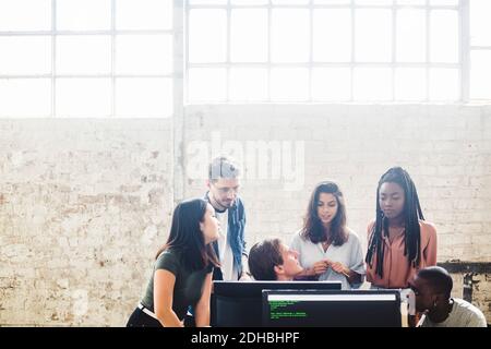 Professional programmers working in team while coding at creative workplace Stock Photo