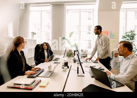 Sales managers brainstorming over business plans at desk in office Stock Photo