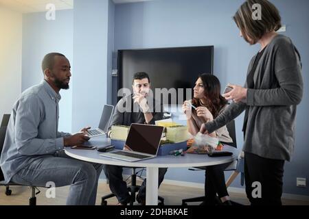 Multi-ethnic engineers at table while working on project in office Stock Photo