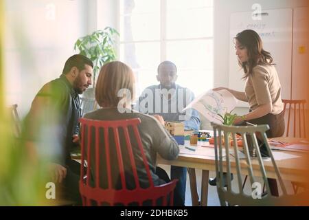 Multi-ethnic male and female engineers are working on project at table in office Stock Photo