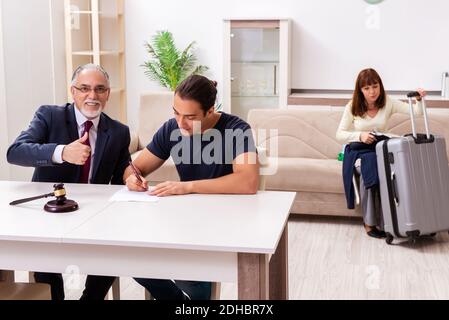 Old experienced judge and young couple in divorcing concept Stock Photo