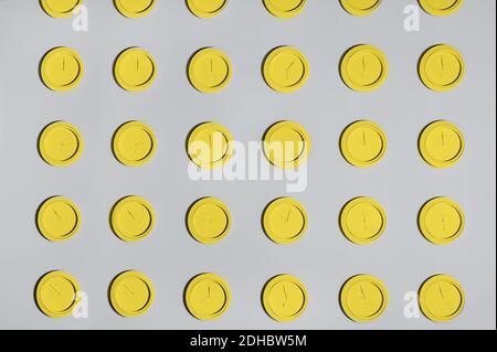 Color of the year yellow and grey background.Grey wall with same round yellow clocks. Time concept background. Trend Color 2021 Stock Photo