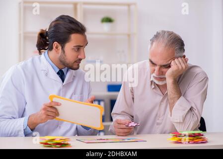 Doctor and patient suffering from Alzheimer disease Stock Photo