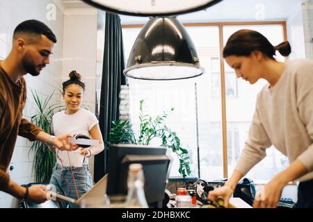 Young multi-ethnic programmers working at small creative office Stock Photo