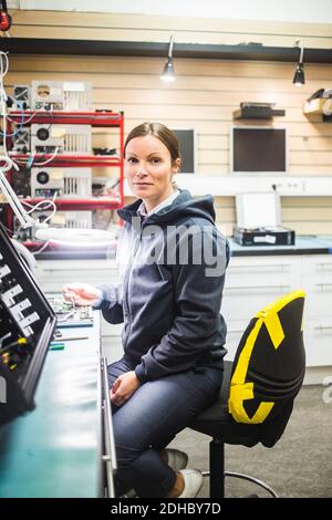 Portrait of mature technician working in electronics store Stock Photo