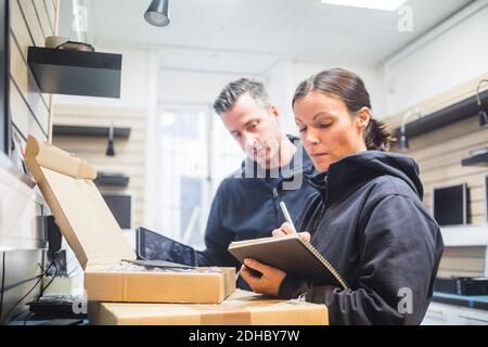 Serious computer engineers working in electronics store Stock Photo