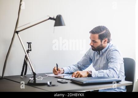 Creative businessman working at desk in office Stock Photo