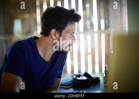 Dedicated businessman working at computer desk in office Stock Photo