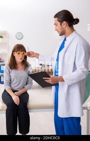 Young woman visiting male doctor oculist Stock Photo