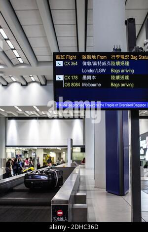 Hong Kong International Airport/Suitcase or luggage with conveyor belt in the airport. Stock Photo