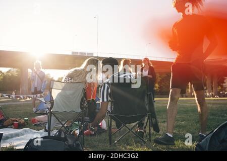 Rear view of loving couple sitting on folding chairs in music concert duiring summer Stock Photo