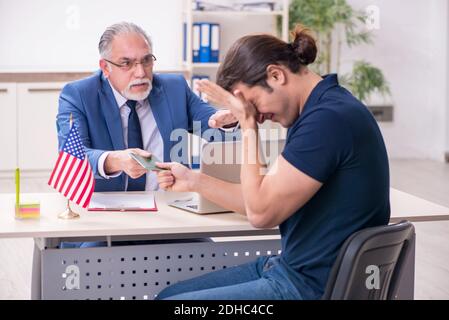 Young man visiting embassy for visa application Stock Photo