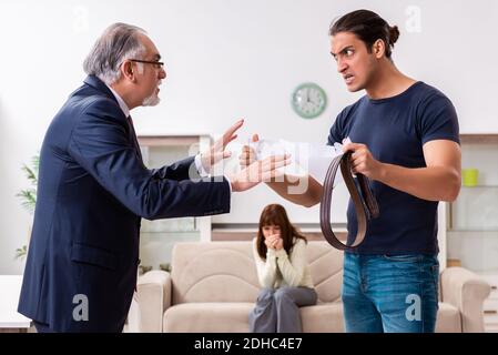 Old experienced judge and young couple in domestic violence conc Stock Photo