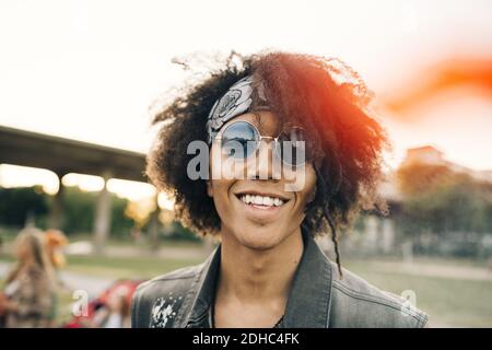 Close-up portrait of smiling young man with curly hair in event Stock Photo