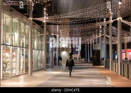 Barcelona, Spain. 10th Dec, 2020. Man walking through an almost empty and Christmas decorated popular shopping center in Barcelona. Due to restrictions, most of the stores are closed. The open ones mostly deliver internet orders. Credit: Dino Geromella / Alamy Live News Stock Photo