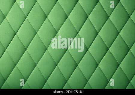 Background texture of pastel dark green genuine leather soft tufted furniture or wall panel upholstery with deep diamond pattern, close up Stock Photo