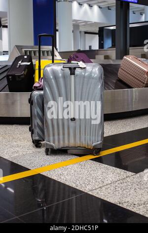 Hong Kong International Airport/Suitcase or luggage with conveyor belt in the airport. Stock Photo