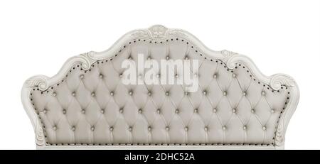 Shaped pastel beige color soft tufted leather capitone bed headboard of Chesterfield style sofa with carved wooden frame, isolated on white background Stock Photo